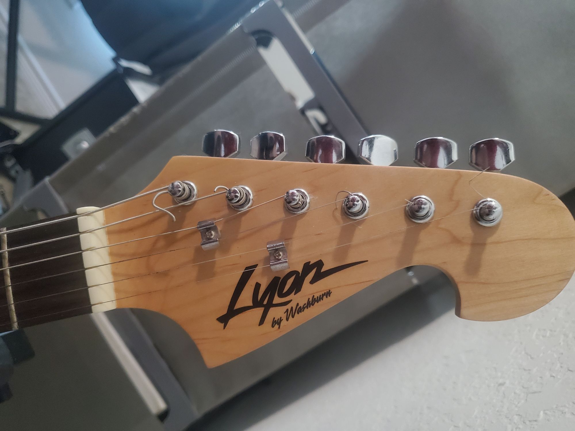 Headstock of Lyon by Washburn electric Strat style guitar